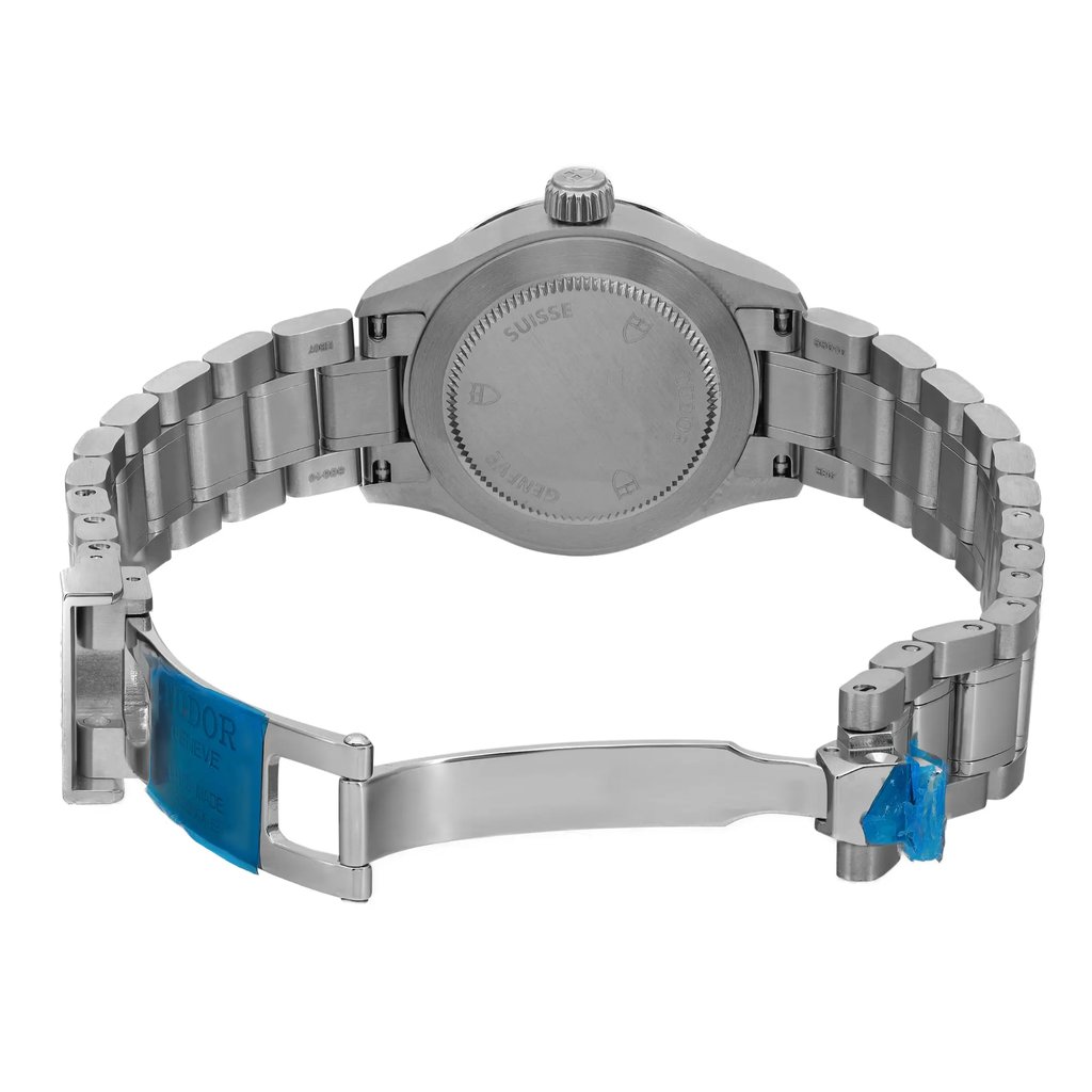 An image of a wristwatch viewed from the back, showcasing the open clasp. The unworn watch is positioned with the back case facing forward, highlighting the metallic bracelet and clasp mechanisms. The angle is straight-on, and the distance is close enough to capture detailed features of the watch's back and bracelet links.