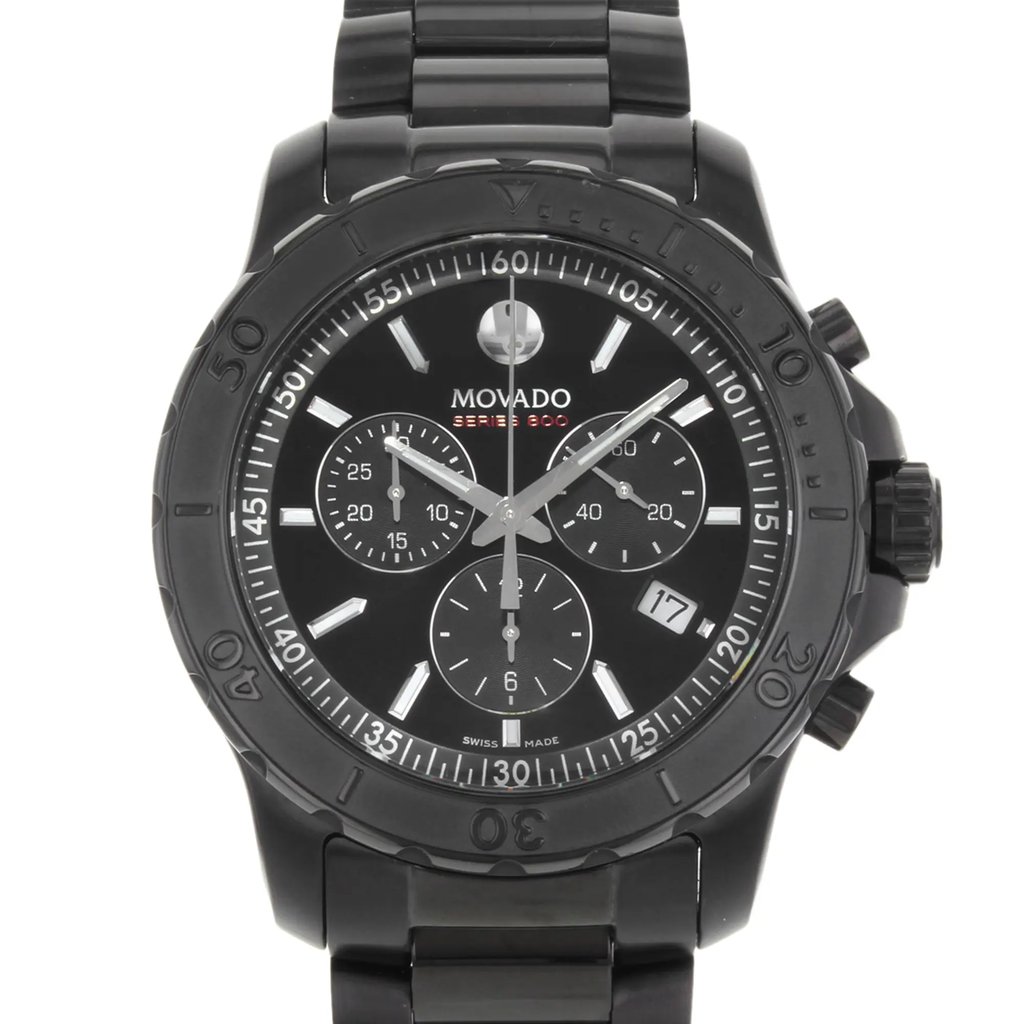 An image of a pre-owned wristwatch displayed in a front close-up shot, focusing on the watch face. The watch features a black dial with multiple sub-dials and a date window. The bezel is marked with minute indicators, and the watch has a sleek black metal band.