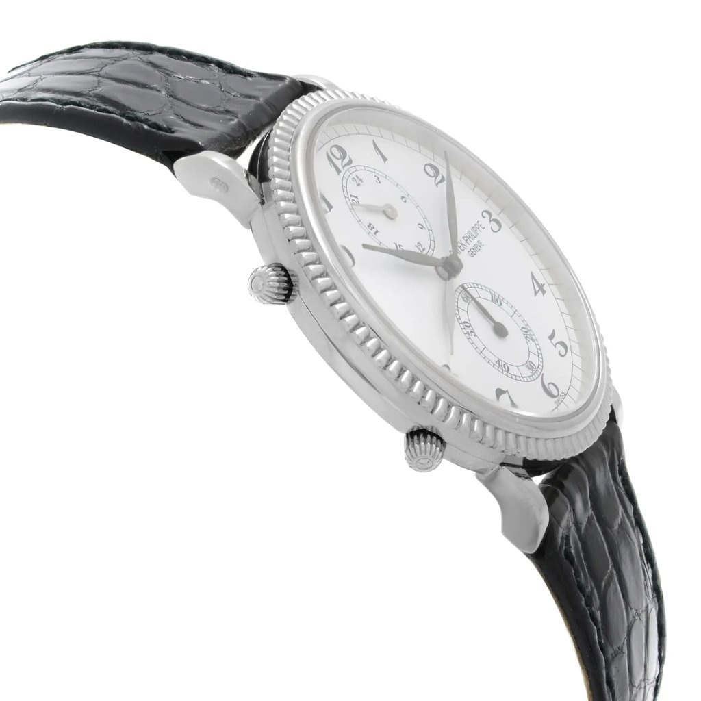 An image of a pre-owned wristwatch viewed from the side profile, opposite the crown. The watch features a textured black leather strap and a silver-toned case with a ridged bezel. The white dial displays black numerals and hands, with two subdials visible. The angle is slightly tilted upwards, providing a clear view of the watch's face and detailing. The shot is taken from a close distance, emphasizing the craftsmanship and design elements.