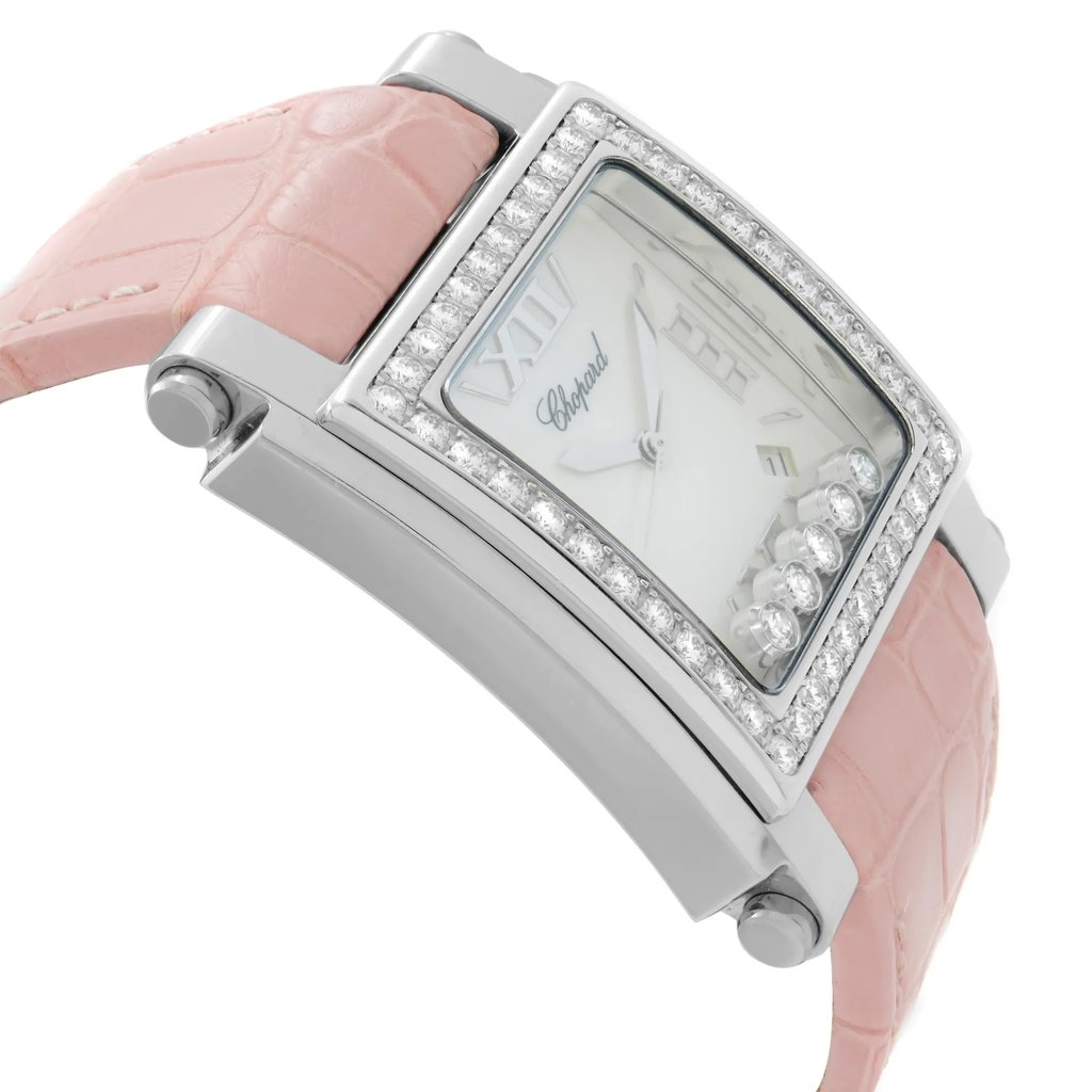 An image of a pre-owned wristwatch shown from a side profile view opposite the crown. The watch features a rectangular face with a diamond-studded bezel and a pink leather strap. The angle highlights the watch's sleek silver casing and elegant design, with the focus on the side and face from a close distance.