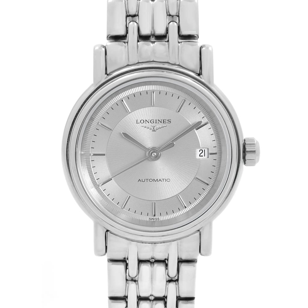 An image of a wristwatch shown from the front in a close-up shot, emphasizing the watch face. The watch features a silver dial with minimalist hour markers and a date window at the three o'clock position. The metallic bracelet is visible at the top and bottom of the watch face, and the crown is positioned on the right side. The watch is in display model condition.