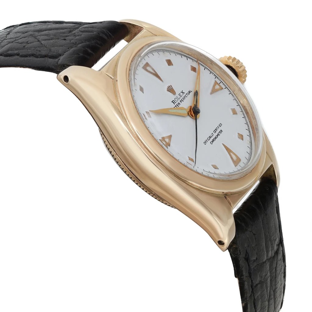 An image of a Wristwatch by Rolex. This Pre Owned item is designed for Unisex Adult, featuring a Casual style. It has a Mechanical (Automatic) movement and an Analog display with a White dial color. The indices include 12-Hour Dial,Arrow Markers,Square Indexes. The band is made of Leather and the case is made of Yellow Gold. The watch has a Round shape with a case size of 31 mm and a case thickness of 14 mm.