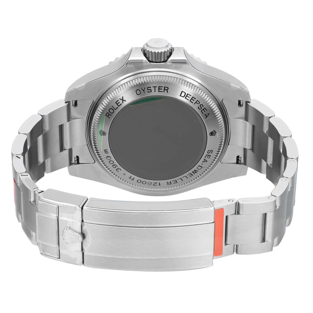 An image of a wristwatch taken from the back view, showcasing the closed clasp. The watch is positioned upright with the focus on the detailed engravings on the case back. The stainless steel bracelet and clasp are clearly visible, highlighting its unworn condition. The angle provides a clear view of the craftsmanship, captured from a close distance.