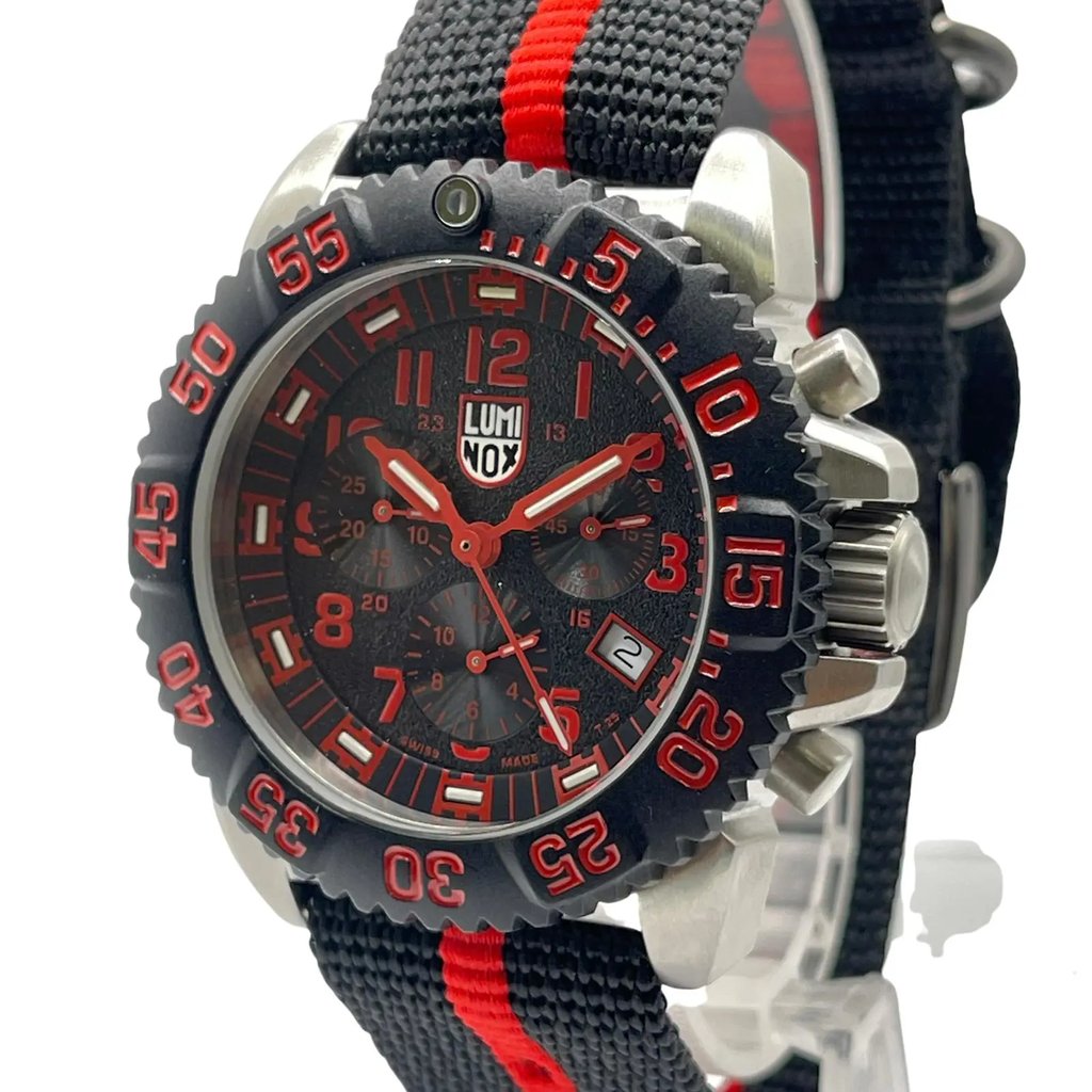 An image of a Wristwatch by Luminox. This Pre Owned item is designed for Men, featuring a Casual,Diver style. It has a Quartz movement and an Analog display with a Black dial color. The indices include 12-Hour Dial,Arabic Numerals,Easy to Read/Large Numerals. The band is made of Nylon and the case is made of Stainless Steel. The watch has a Round shape with a case size of 44 mm and a case thickness of 14 mm.