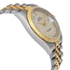 An image of a pre-owned men's luxury Rolex wristwatch. The side profile view, opposite the crown, showcases the round stainless steel case and gold bezel. The cream dial features a date indicator. The watch is in good condition, and the angle highlights the two-tone metal bracelet from a close distance.