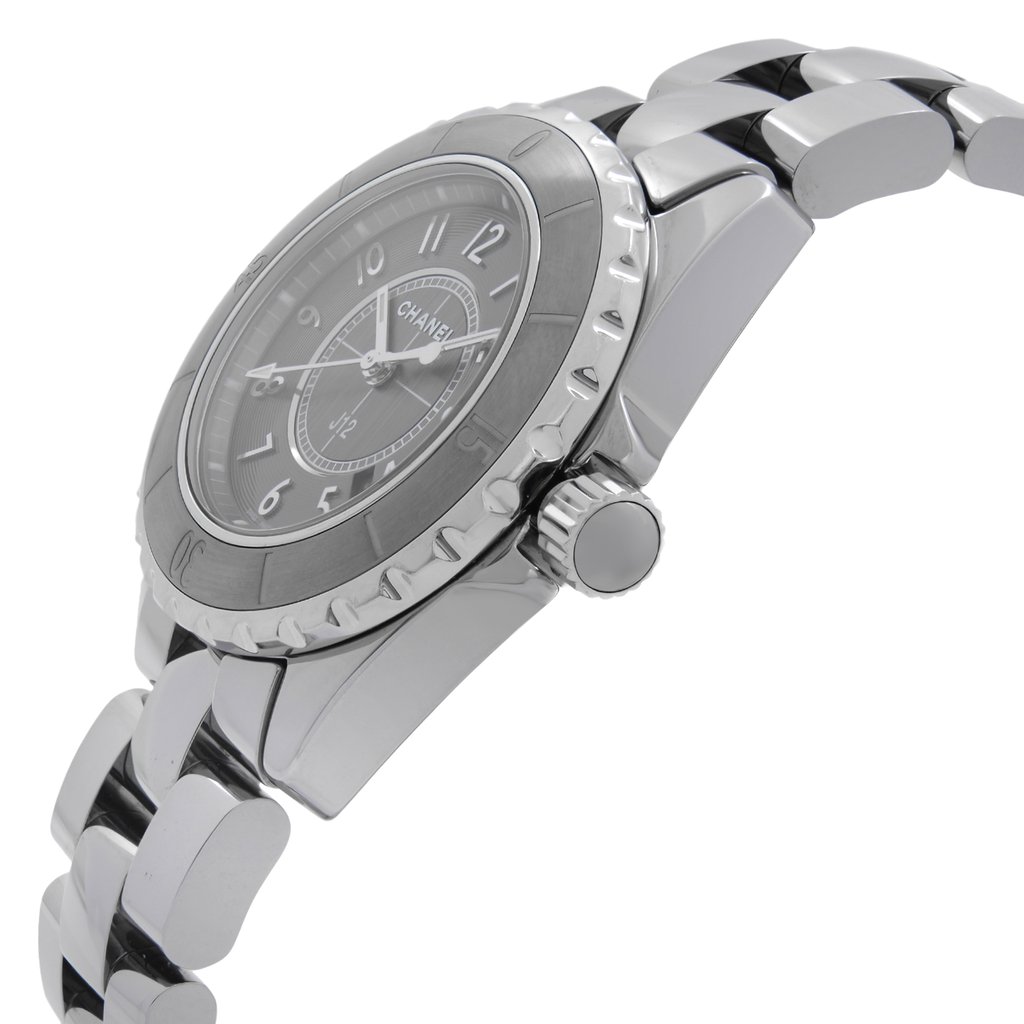 An image of a pre-owned wristwatch captured from a side profile view, highlighting the crown prominently. The watch features a metallic band and a round face with visible numbers. The angle showcases the watch at a slight tilt, emphasizing its sleek design and craftsmanship.