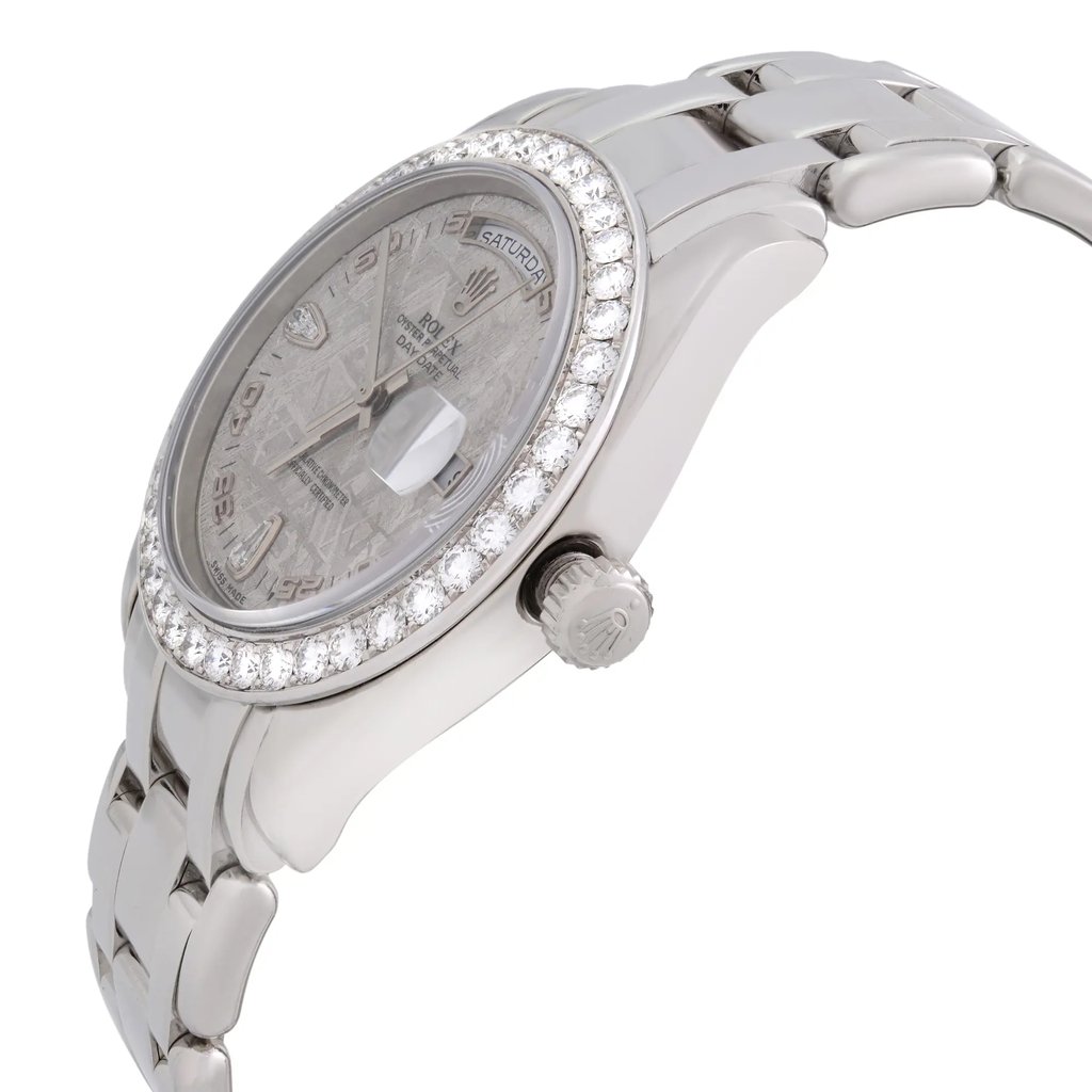 An image of a pre-owned wristwatch displayed from a back view angle, focusing on the closed clasp. The watch features a metallic band and a detailed face with a decorative bezel. The photograph is taken from a close distance, highlighting the intricate details of the watch's design and condition.