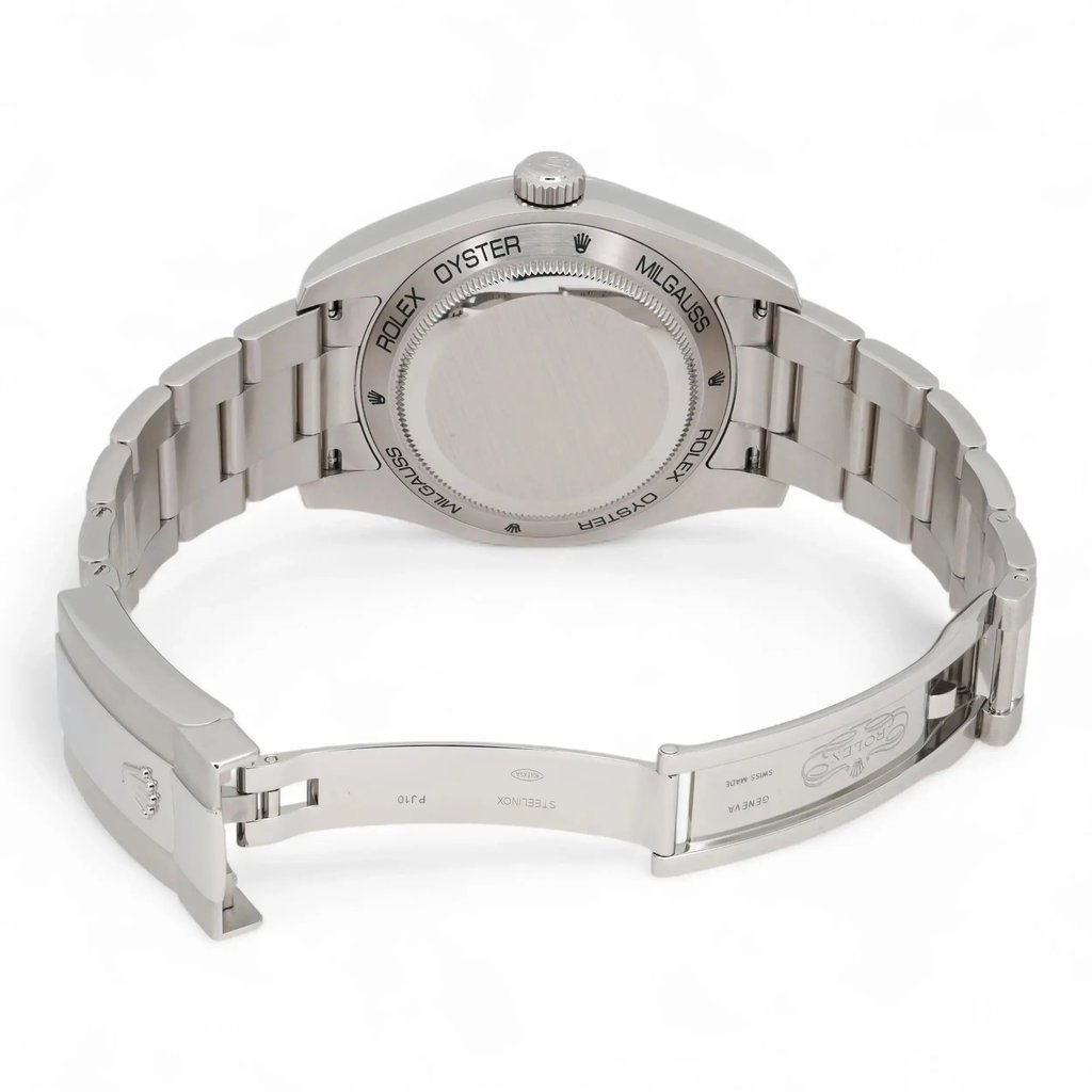 An image of a pre-owned men's Rolex wristwatch viewed from the back at a slight angle, showcasing the closed clasp and stainless steel bracelet. The watch is positioned on a neutral background, photographed at a medium distance, highlighting the engraved details on the case back and clasp. The luminous hands feature is not visible in this view.