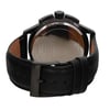 An image of a pre-owned men's GUESS wristwatch, shown from the back at a close distance and slightly angled upward. The focus is on the stainless steel case back, with visible engravings, and the attached black leather strap featuring a buckle clasp. The watch includes features like a chronograph, date indicator, and luminous hands.