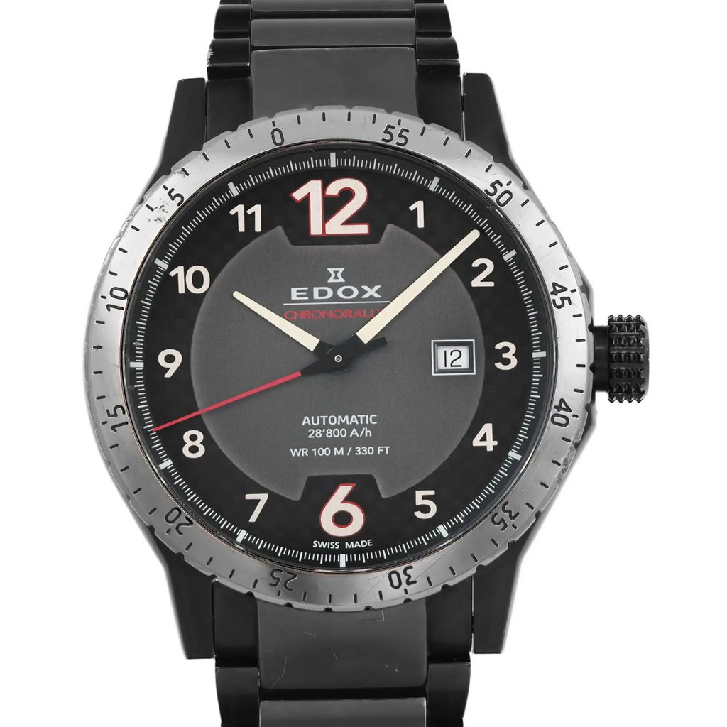 An image of a pre-owned wristwatch shown in a front close-up shot of the watch face. The watch features a black and gray design with large numerals and a date display. The bezel is silver-toned with minute markers, and the hands are luminescent. The brand name is visible in the center of the dial.