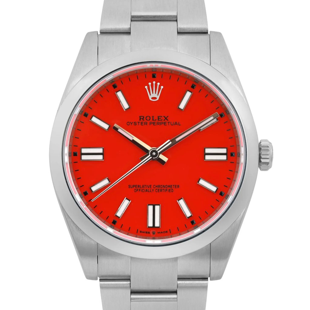 An image of a pre-owned men's Rolex wristwatch, positioned vertically and viewed from the front at a close angle. The watch features a vibrant red dial with luminous hands and hour markers, enclosed in a stainless steel case with a matching bracelet. The brand's name and logo are visible on the dial.