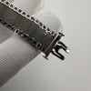 An image of a pre-owned Tissot women's wristwatch, focusing on the clasp and mesh band. The photo is taken at a close distance, angled to show the side of the clasp mechanism and the texture of the mesh band. The clasp is in an open position and exhibits signs of wear and damage, particularly on the metal mesh band which appears frayed at the edges.