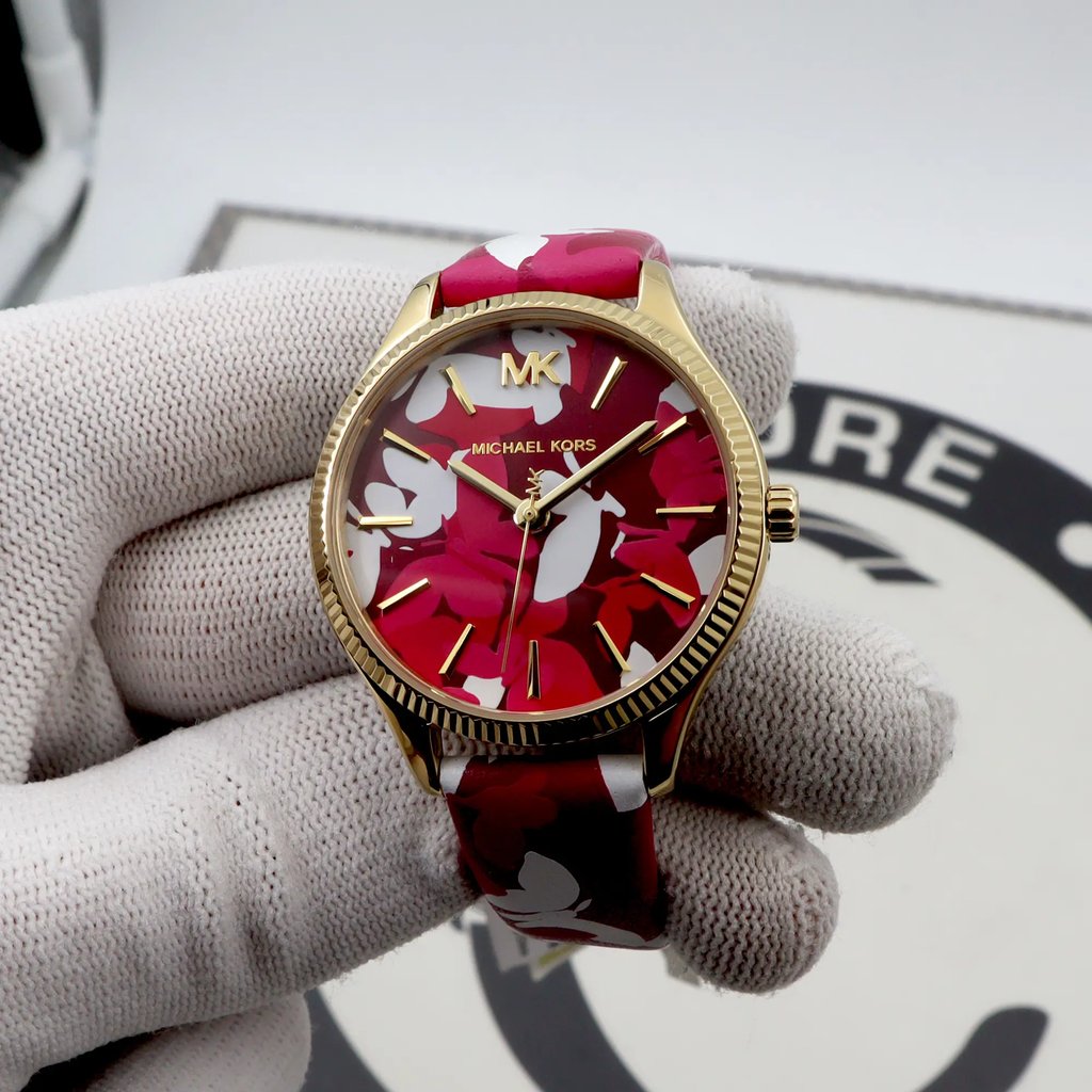 An image of a Wristwatch by Michael Kors. This Display Model item is designed for Women, featuring a Casual style. It has a Quartz movement and an Analog display with a Pink dial color. The indices include 12-Hour Dial,Stick Indexes. The band is made of Leather and the case is made of Stainless Steel. The watch has a Round shape with a case size of 36 mm and a case thickness of 8 mm.