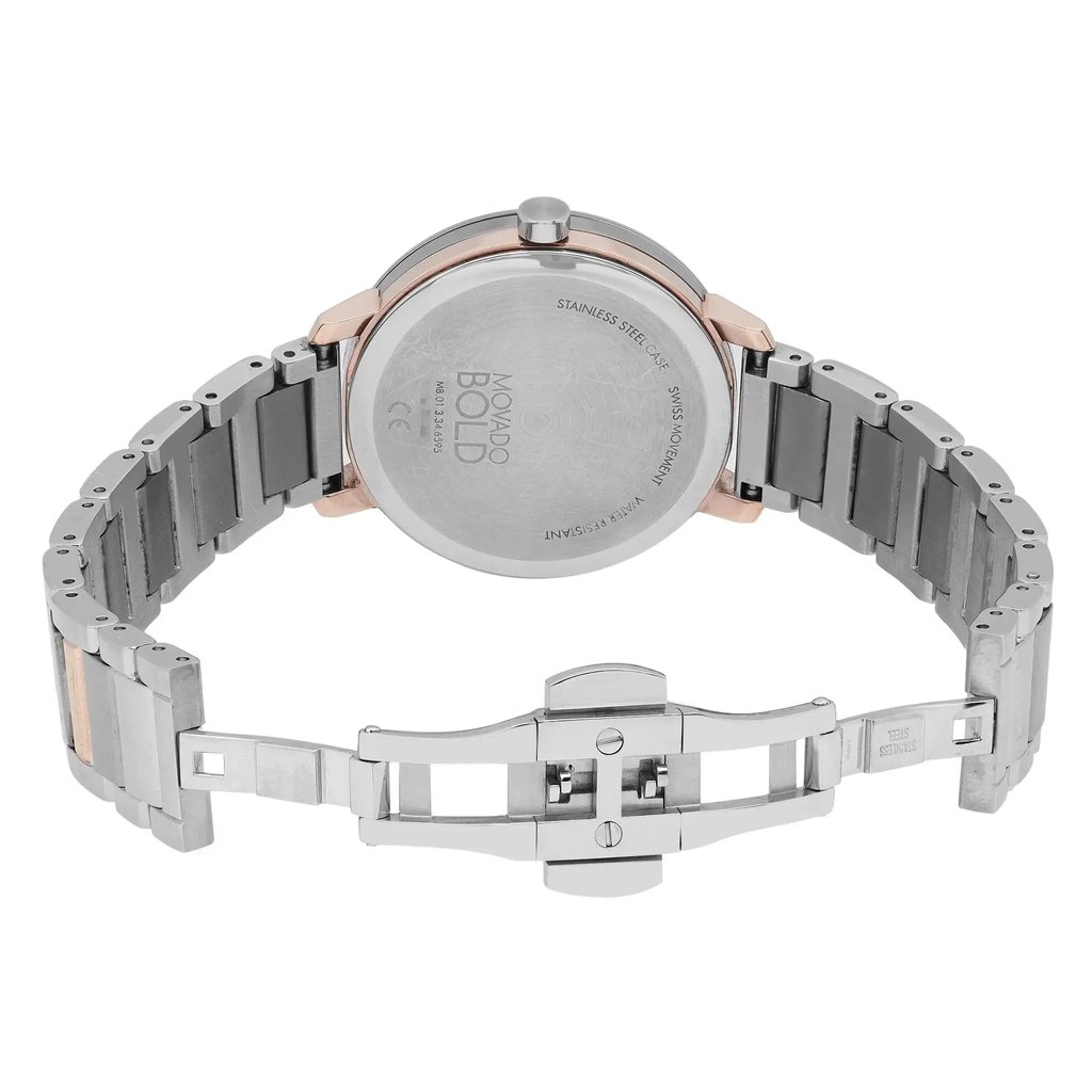 An image of a pre-owned wristwatch viewed from the back, showcasing an open clasp. The watch is positioned centrally with the metal bracelet extended. The angle is straight-on, capturing the stainless steel back case and the intricate details of the open clasp mechanism. The distance is close enough to clearly display the watch's branding and inscriptions on the back.