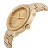 An image of a pre-owned wristwatch displayed in a side profile view, showcasing the crown prominently. The watch features a gold-toned case and matching bracelet, with the face angled slightly upward to reveal its minimalist design and sleek, polished finish. The image is taken from a moderate distance, highlighting the watch's elegant and sophisticated appearance.
