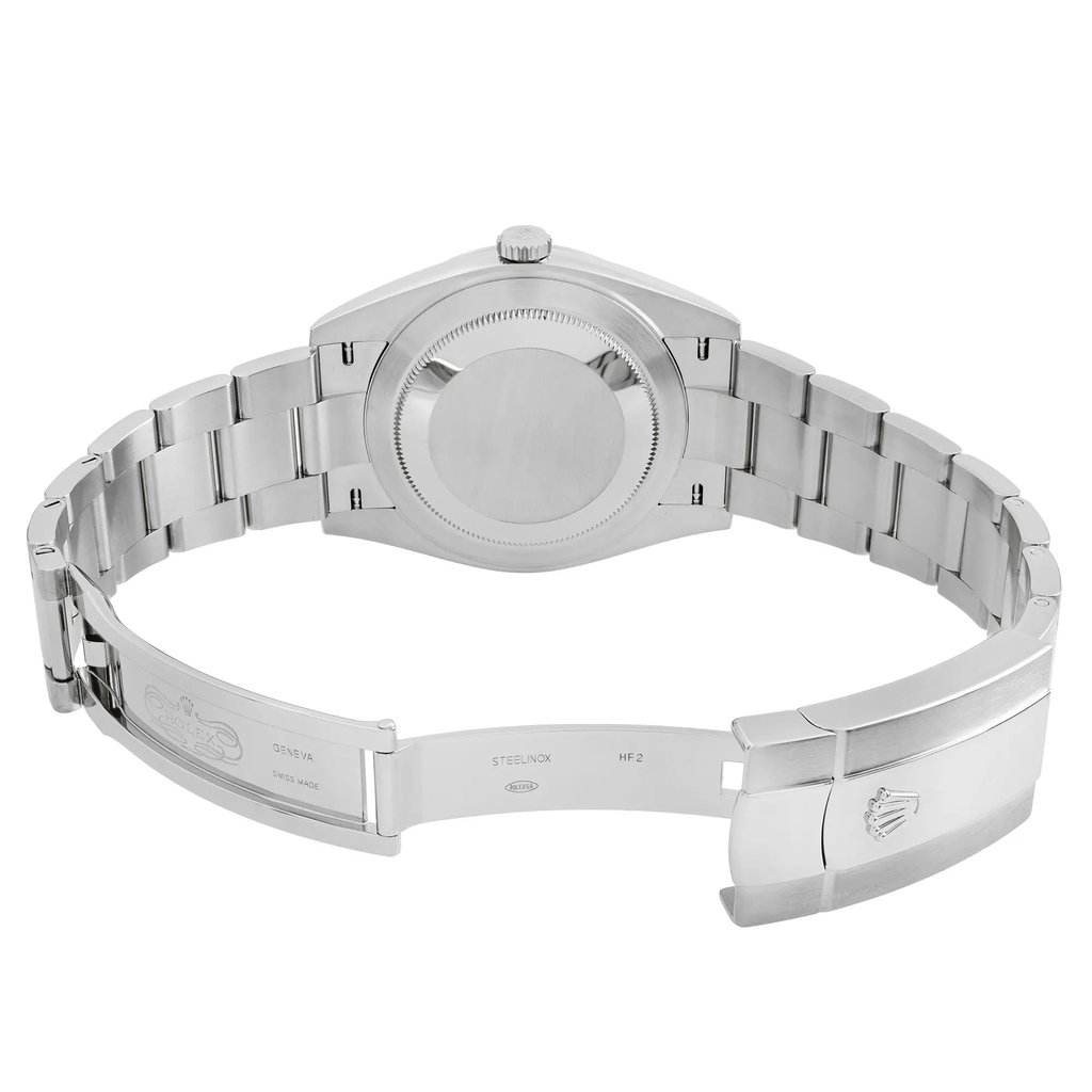 An image of a wristwatch taken from the back view, showcasing the open clasp. The watch is positioned horizontally, with the band extending outward. The image is captured at a close distance, emphasizing the unworn condition and the detailed craftsmanship of the metal links and clasp.