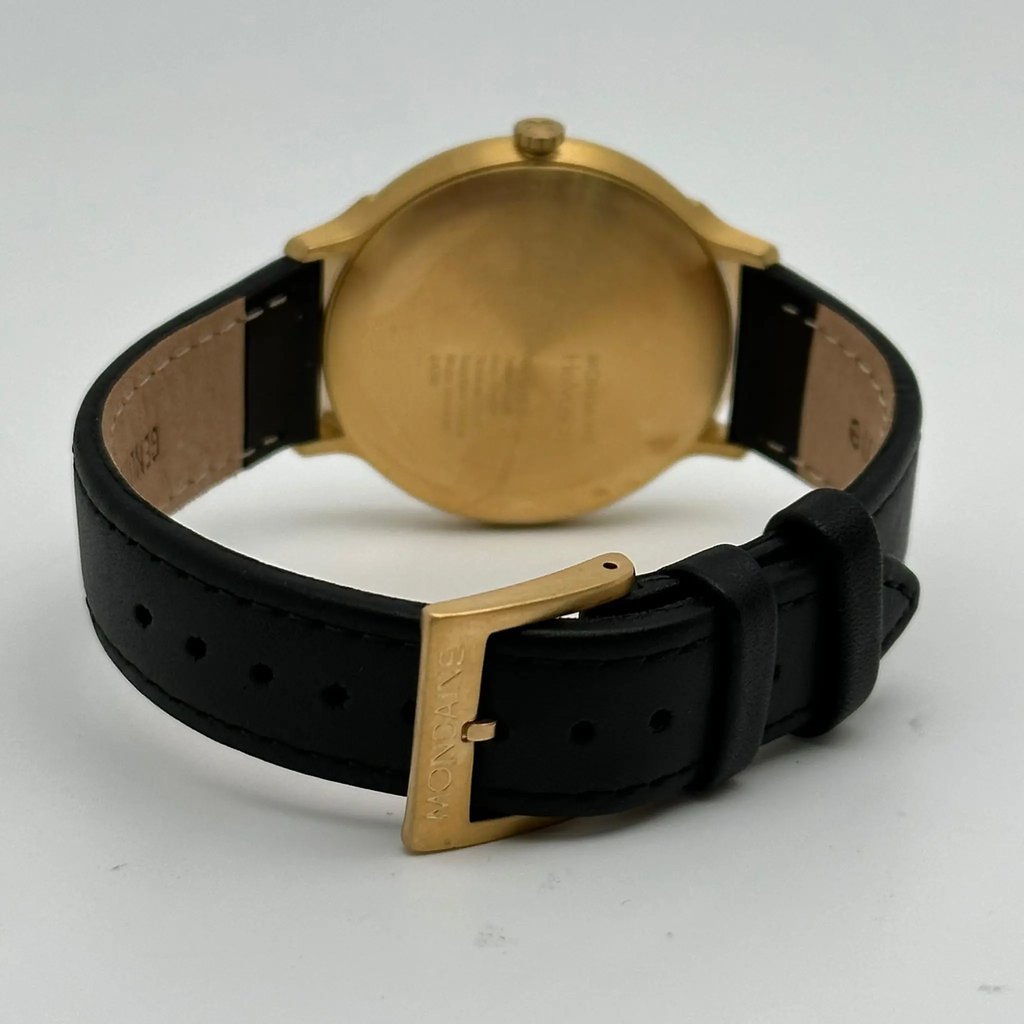 An image of a Wristwatch by Mondaine. This Display Model item is designed for Men, featuring a Casual,Classic,Dress/Formal style. It has a Quartz movement and an Analog display with a White dial color. The indices include 12-Hour Dial,Stick Indexes. The band is made of Leather and the case is made of Stainless Steel. The watch has a Round shape with a case size of 38 mm and a case thickness of 7 mm.