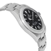 An image of a pre-owned wristwatch captured from a side profile view opposite the crown. The watch features a stainless steel bracelet and a black dial with silver hour markers and hands. The angle highlights the sleek design and curvature of the watch case, emphasizing its polished finish. The photograph is taken at a close distance, showcasing the details and craftsmanship of the timepiece.
