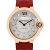 An image of a pre-owned Cartier women's wristwatch captured from a front-facing angle at a close distance. The watch features a round face with a rose gold bezel and a silver-toned dial adorned with diamond hour markers. The watch hands are elegantly styled in a blue tone. It has a distinctive crown guard on the right side, and the strap is crafted from red leather, adding a touch of luxury to the timepiece.