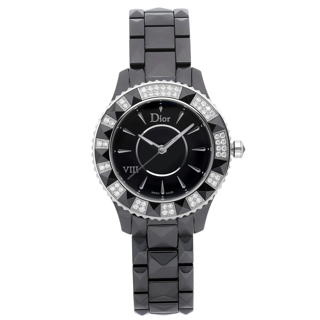 An image of a Wristwatch by Dior. This Display Model item is designed for Women, featuring a Luxury style. It has a Quartz movement and an Analog display with a Black dial color. The indices include 12-Hour Dial,Stick Indexes. The band is made of Ceramic and the case is made of Ceramic. The watch has a Round shape with a case size of 33 mm and a case thickness of 10 mm.