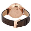 An image of a pre-owned Skagen wristwatch positioned at a slight angle, viewed from the back. The focus is on the rose gold case and the embossed brand details on the back cover. The dark brown leather strap is visible, with the buckle prominently featured in the foreground. The watch is captured from a close distance, highlighting the texture and details of the materials.