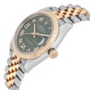 An image of a pre-owned men's Rolex wristwatch, viewed from a slightly angled side perspective. The watch features a two-tone metal bracelet with alternating gold and stainless steel links. The face is gray with Roman numerals, a date indicator, and luminous hands. The gold bezel is fluted, and the crown is visible on the right side. The angle highlights the watch's elegant design and craftsmanship.