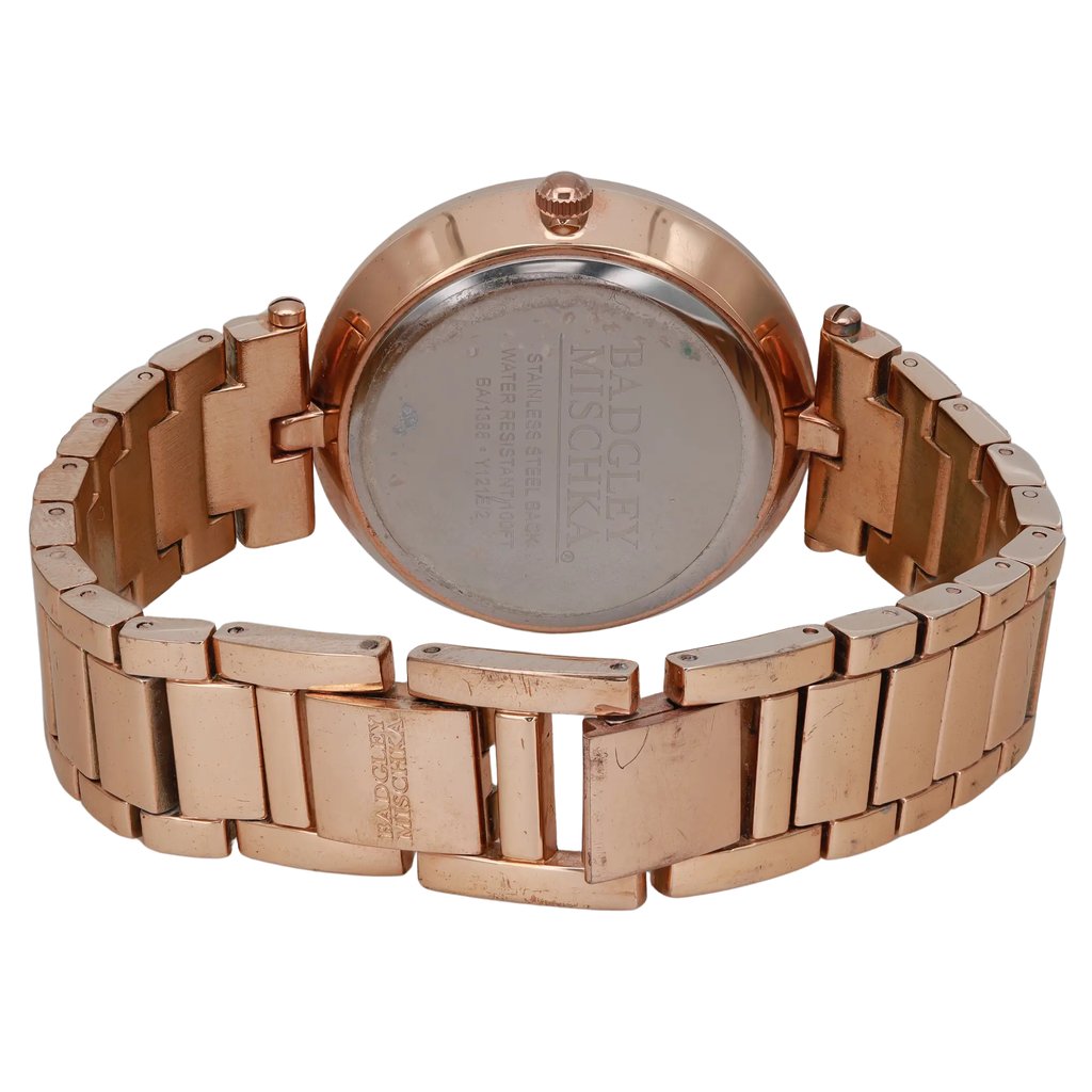 An image of a Wristwatch by Badgley Mischka. This Pre Owned item is designed for Women, featuring a Dress/Formal style. It has a Quartz movement and an Analog display with a MOP dial color. The indices include 12-Hour Dial,No Hour Marks. The band is made of Stainless Steel and the case is made of Stainless Steel. The watch has a Round shape with a case size of 36 mm and a case thickness of 9.5 mm.
