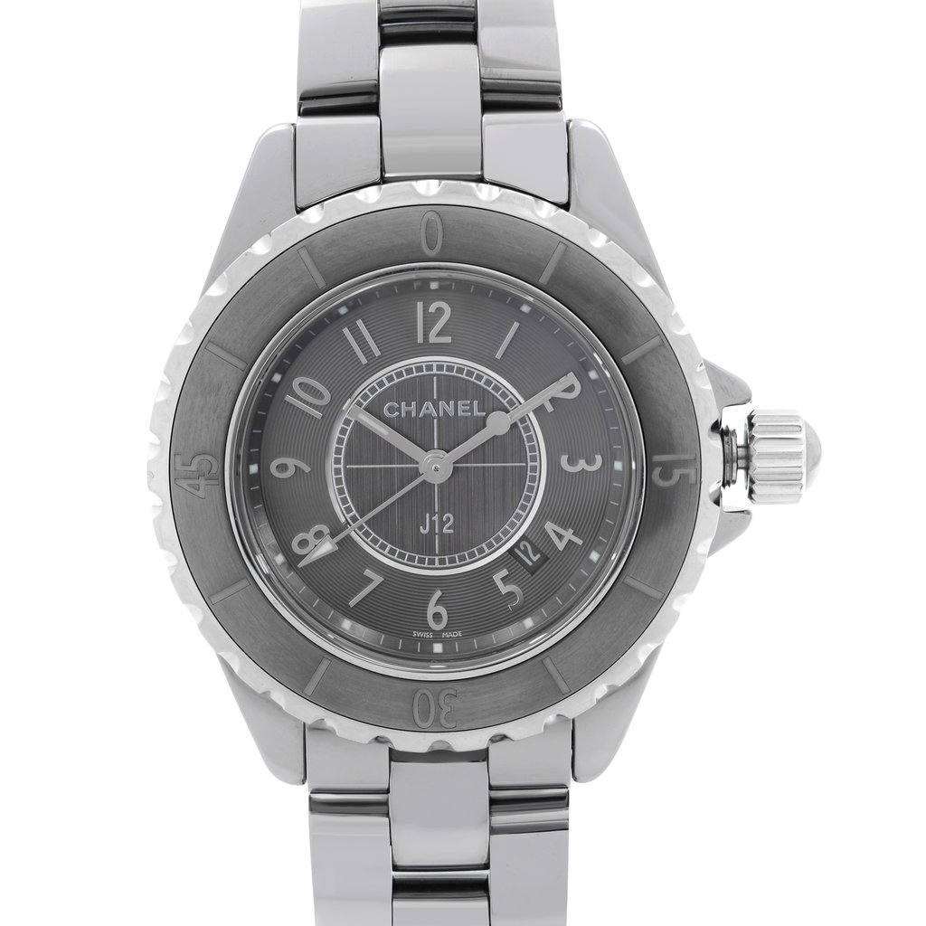 An image of a pre-owned wristwatch taken from a front close-up angle, showcasing the watch face. The watch features a metallic silver bezel and a matching bracelet. The brand name is visible on the dial, which displays numerals and a date window.