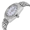 An image of a pre-owned men's TUDOR wristwatch featuring a white dial with day and date displays. The watch is positioned at a slight angle, showcasing the right side and face clearly. The stainless steel bracelet and luminous hands are visible, indicating its sophisticated design. The photograph is taken from a close distance, highlighting the intricate details of the watch's bezel and crown.