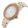 An image of a Bulova women's dress/formal wristwatch in display model condition. The watch is shown in a side profile view with the crown visible. It features a round, silver sector-patterned dial encircled by a gold-tone bezel adorned with diamonds. The stainless steel band has gold-tone accents. The watch has luminous hands and day/date and GMT functions. The photograph is taken from a close distance, capturing the watch at a slight angle to emphasize the side profile and crown details.