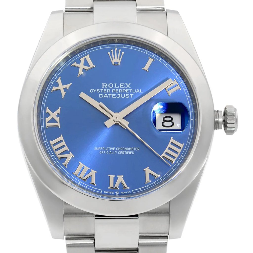 An image of a new wristwatch, taken from a front close-up angle, showcasing the watch face prominently. The dial is a rich blue with silver Roman numerals and a date window at the 3 o'clock position. The watch features a stainless steel case and a polished bezel, with the crown visible on the right side.