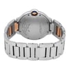 An image of a pre-owned wristwatch viewed from the back, showcasing the clasp in a closed position. The angle captures the watch from a slightly elevated perspective, focusing on the stainless steel back and the bracelet. The watch features a visible crown with a blue accent at the top center. The image is taken from a close distance, emphasizing the details and inscriptions on the back of the watch.