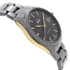 An image of a pre-owned wristwatch taken from a side profile view opposite the crown. The watch features a sleek design with a dark face and gold hour markers. The case has a metallic finish with a gold accent along the side. The bracelet is metallic and composed of linked segments. The angle showcases the watch's thickness and the curvature of its strap.