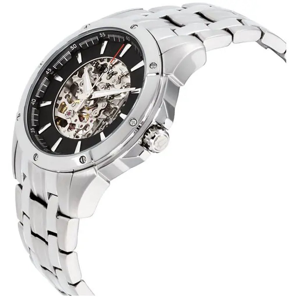 An image of a pre-owned Bulova men's wristwatch in a side profile view, highlighting its crown. The watch features a skeleton dial with a black background, luminous hands, and a round stainless steel case. The bezel is also made of steel, and the watch is equipped with a stainless steel band. The skeleton dial allows a view into the watch's internal workings, and the timepiece exudes a sporty yet elegant style. The photo is taken at a close distance, emphasizing the watch's side angle to showcase its depth and the detailing of the crown and case.