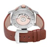 An image of a wristwatch showcasing the back view. The focus is on the closed clasp and the visible mechanical movement. The watch has a brown leather strap, and the metal parts of the clasp are engraved with the brand name. The angle is directly from behind, capturing the intricate details of the display model at a close distance.