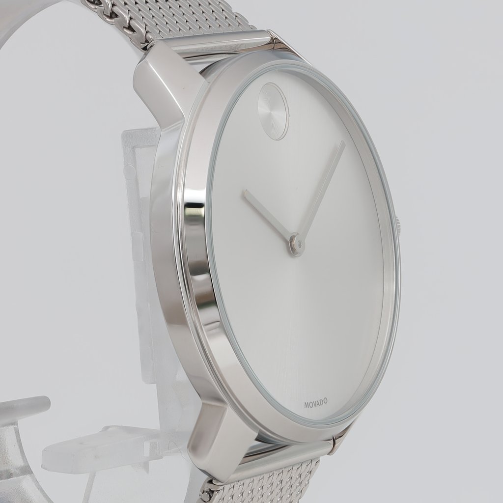 An image of a Wristwatch by Movado. This Unworn item is designed for Men, featuring a Casual style. It has a Quartz movement and an Analog display with a Silver dial color. The indices include 12-Hour Dial,No Hour Marks. The band is made of Stainless Steel and the case is made of Stainless Steel. The watch has a Round shape with a case size of 42 mm and a case thickness of 7 mm.