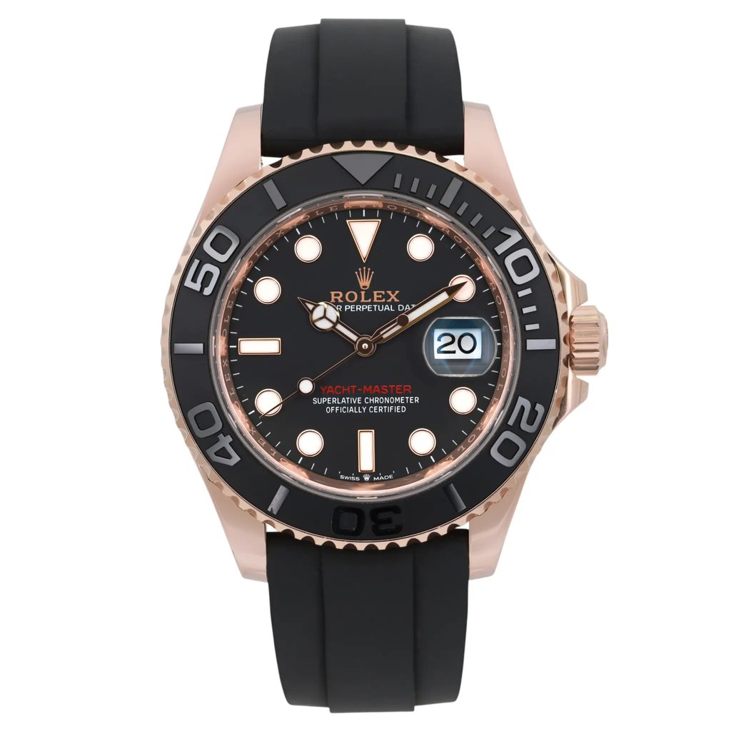 An image of a pre-owned men's Rolex Yacht Master 40mm 18k Rose Gold Rubber Black Dial Automatic wristwatch, taken from a front-facing angle at a close distance. The watch features a black dial with luminous hands, a date indicator, and a black bezel with bold numerals. The case is rose gold, and the watch has a black rubber strap.Minor scratch on the bezel between 30 and 40. It shows light signs of wear. The brand name and model, "Yacht-Master," are visible on the dial.