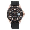 An image of a pre-owned men's Rolex Yacht Master 40mm 18k Rose Gold Rubber Black Dial Automatic wristwatch, taken from a front-facing angle at a close distance. The watch features a black dial with luminous hands, a date indicator, and a black bezel with bold numerals. The case is rose gold, and the watch has a black rubber strap.Minor scratch on the bezel between 30 and 40. It shows light signs of wear. The brand name and model, "Yacht-Master," are visible on the dial.