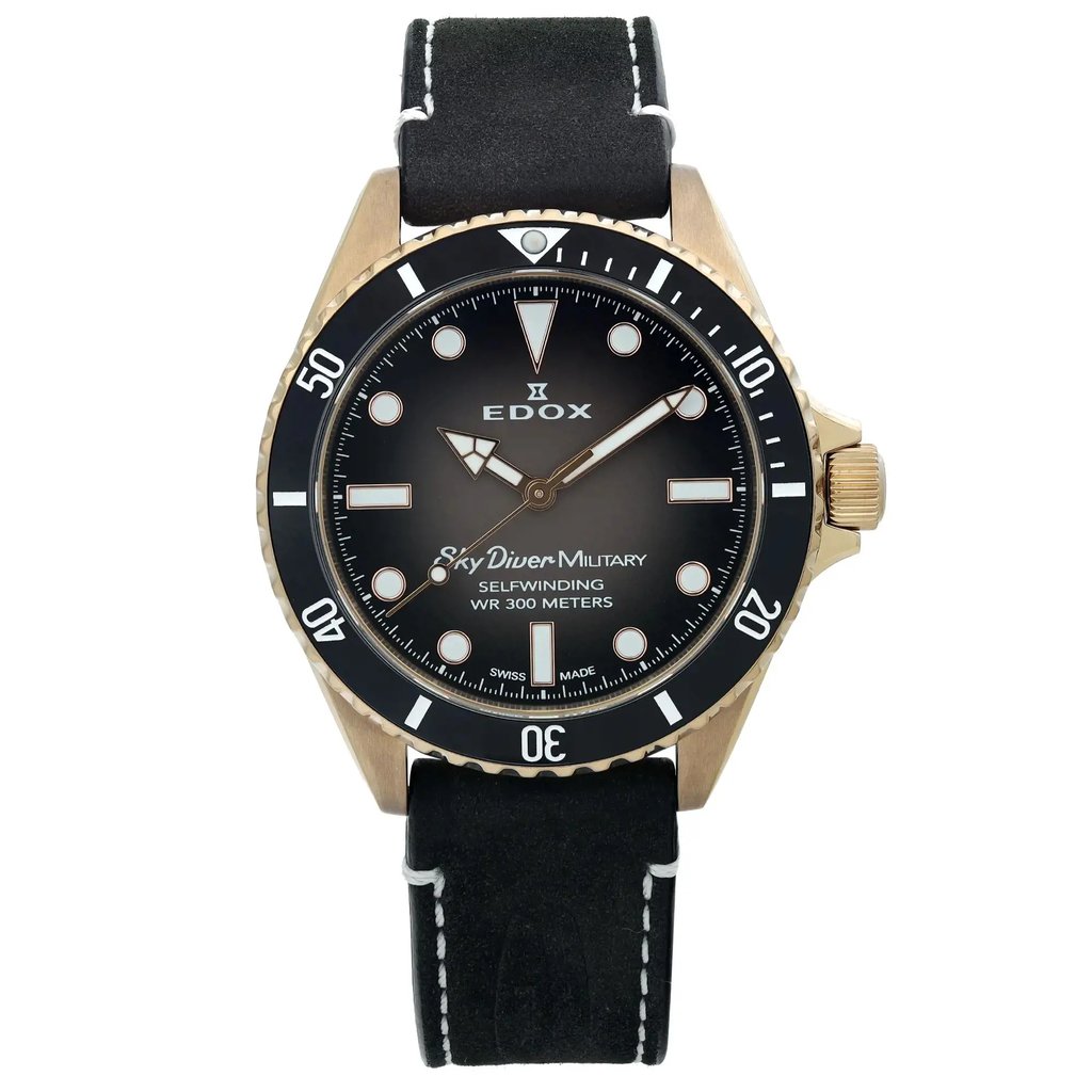 An image of a pre-owned wristwatch displayed from a front full frontal view. The watch features a black dial with white markers and hands, encased in a metallic frame. The bezel is marked with numerals at intervals. The strap is black with white stitching, enhancing its refined appearance. The angle and distance provide a clear, detailed view of the watch's face and features.