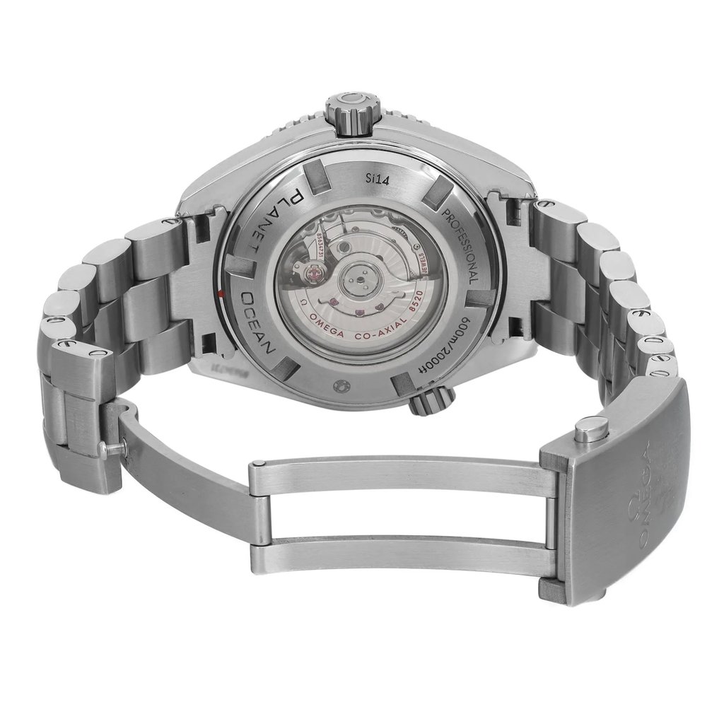 An image of a pre-owned women's OMEGA wristwatch showcasing the back view with an open clasp. The watch features a round stainless steel case and exhibition caseback, allowing a view of the internal mechanism. The stainless steel band is partially visible, ending in a fold-over clasp with a double push button. The angle provides a clear view of the clasp and back, emphasizing the detailed craftsmanship and branding engraved on the caseback.