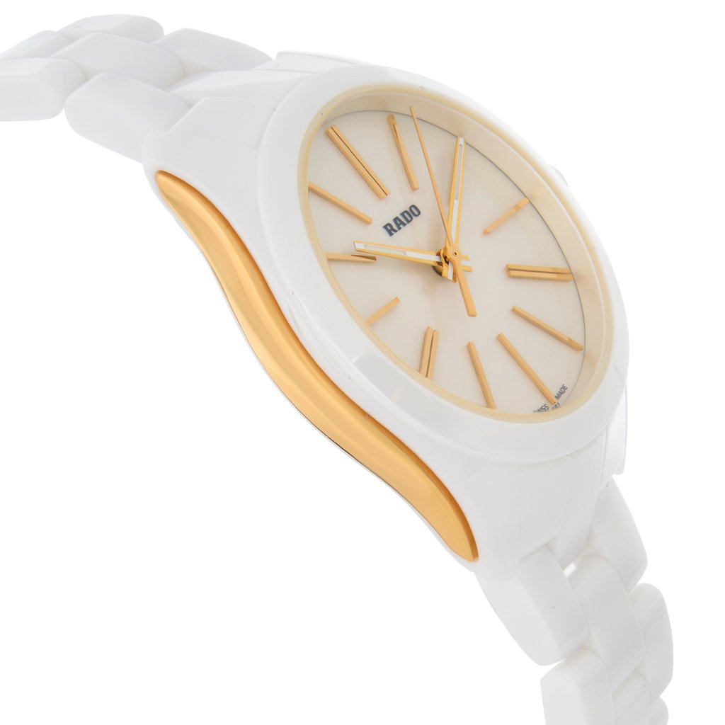 An image of a display model wristwatch viewed from the side profile, opposite the crown. The watch features a white band and case with gold-tone accents. The angle showcases the watch's sleek design, emphasizing the contrast between the white and gold elements. The photo is taken at a close distance, highlighting the watch's face and the texture of the band.