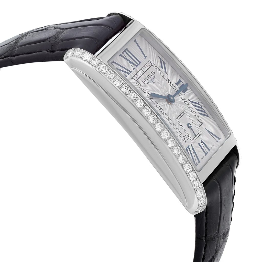 An image of an unworn Longines women's luxury wristwatch, presented in a side profile view opposite the crown. The watch features a silver guilloche dial, stainless steel bezel, and a rectangular stainless steel case adorned with diamonds along the side. It is attached to a black leather band. The image is taken from a close distance, focusing on the watch at a slightly angled position to highlight the side details.
