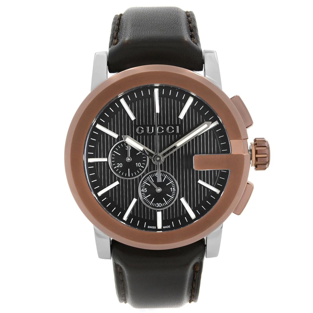 An image of a pre-owned Gucci men's wristwatch in good condition, presented in a front full frontal view. The watch features a round stainless steel case with a bronze bezel, a black teaked dial, and stick indexes. The dial includes a 12-hour display with multiple subdials, luminous hands, and a small seconds subdial. The watch is complemented by a leather band and showcases a dress/formal style. The watch is photographed up close, occupying most of the frame, allowing for clear visibility of the watch details.