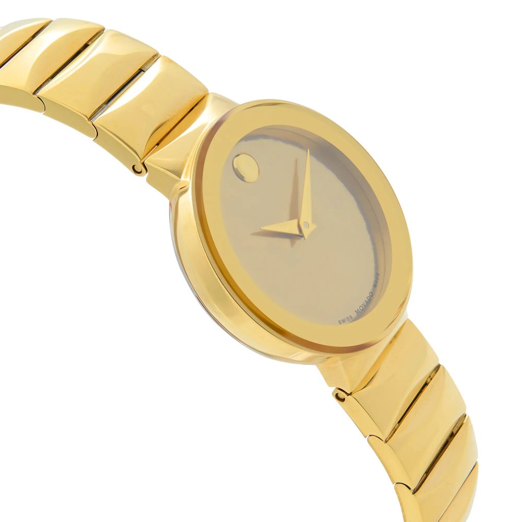 An image of a wristwatch shown from a side profile view opposite the crown, highlighting the sleek design of the bracelet and case. The watch is positioned at a slight angle, displaying its new condition with defects. The photo is taken from a medium distance, focusing on the gold-toned finish and minimalist dial, with a smooth transition between the band and watch face.