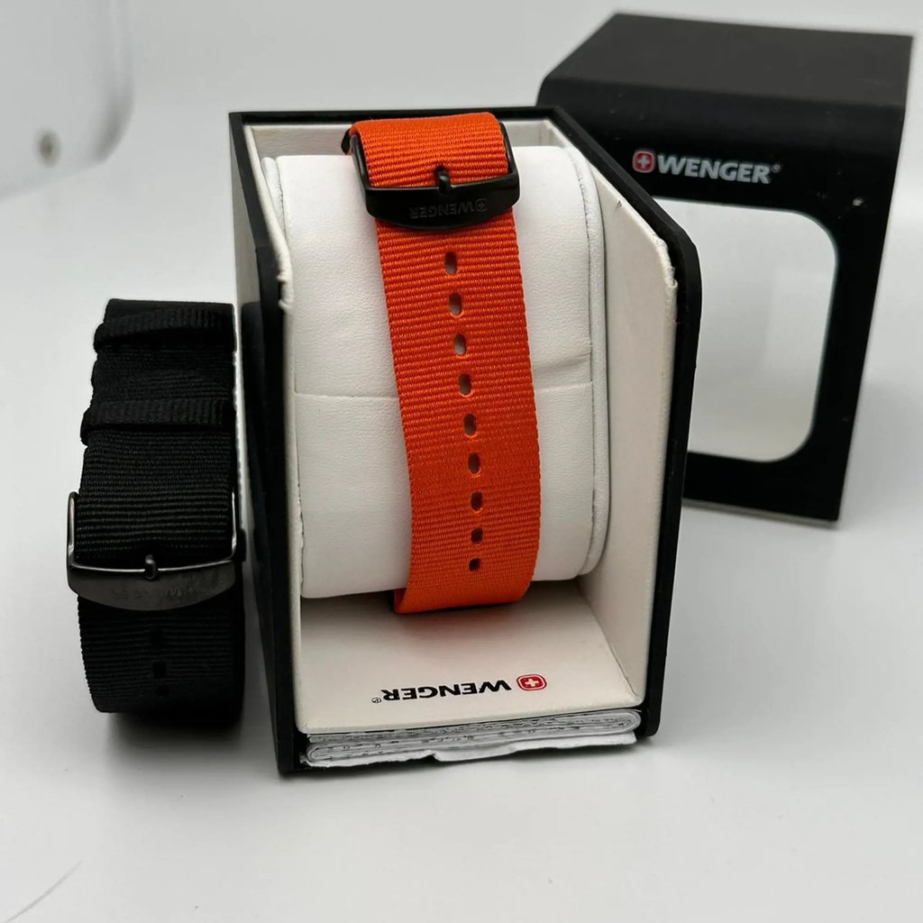 An image of a Wristwatch by Wenger. This Display Model item is designed for Men, featuring a Casual style. It has a Quartz movement and an Analog display with a Black dial color. The indices include 12-Hour Dial,Arabic Numerals,Stick Indexes. The band is made of Nylon and the case is made of Stainless Steel. The watch has a Round shape with a case size of 41 mm and a case thickness of 10 mm.