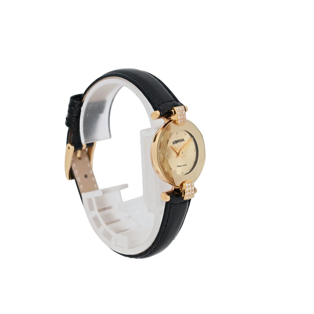 An image of a pre-owned JOWISSA women's wristwatch positioned at a three-quarter angle, showcasing its elegant design. The watch features a gold-tone round face with minimalistic hour markers, set in a gold case. The black leather strap adds a classic touch, and the watch is displayed on a white stand that highlights its sophisticated appearance. The photo is taken at a close distance to capture the intricate details of the watch's face and strap.