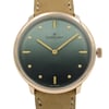 An image of a wristwatch taken from a front close-up angle, showcasing the unworn watch face. The watch features a green dial with gold hour markers and hands. The brand name "Gomelsky" is visible on the face, and the watch is complemented by a beige leather strap.