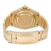 An image of a pre-owned men's Rolex wristwatch viewed from the back. The watch is positioned upright, displaying the gold case and bracelet at a slight angle. The focus is on the case back and bracelet clasp, captured from a close distance.