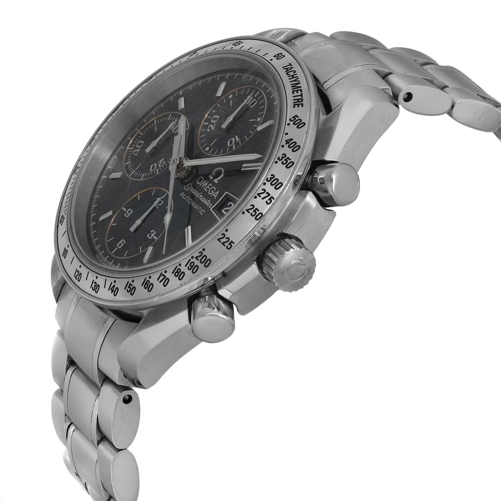 An image of a pre-owned wristwatch captured from a side profile view, highlighting the crown and pushers. The angle showcases the watch at a slightly elevated position, focusing on the metal bracelet and detailed tachymeter on the bezel. The watch face displays subdials and the brand logo, with a close-up distance emphasizing the intricate design elements.