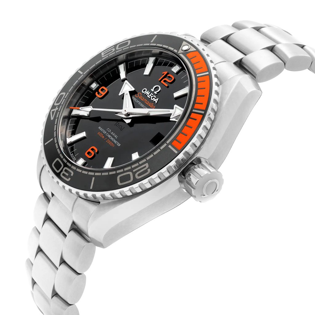 An image of a wristwatch taken from a side profile view, showcasing the crown prominently. The angle highlights the thickness of the case and the design of the bracelet links. The watch face is partially visible, displaying a black dial with orange and white accents. The image is a close-up shot of a display model in excellent condition.